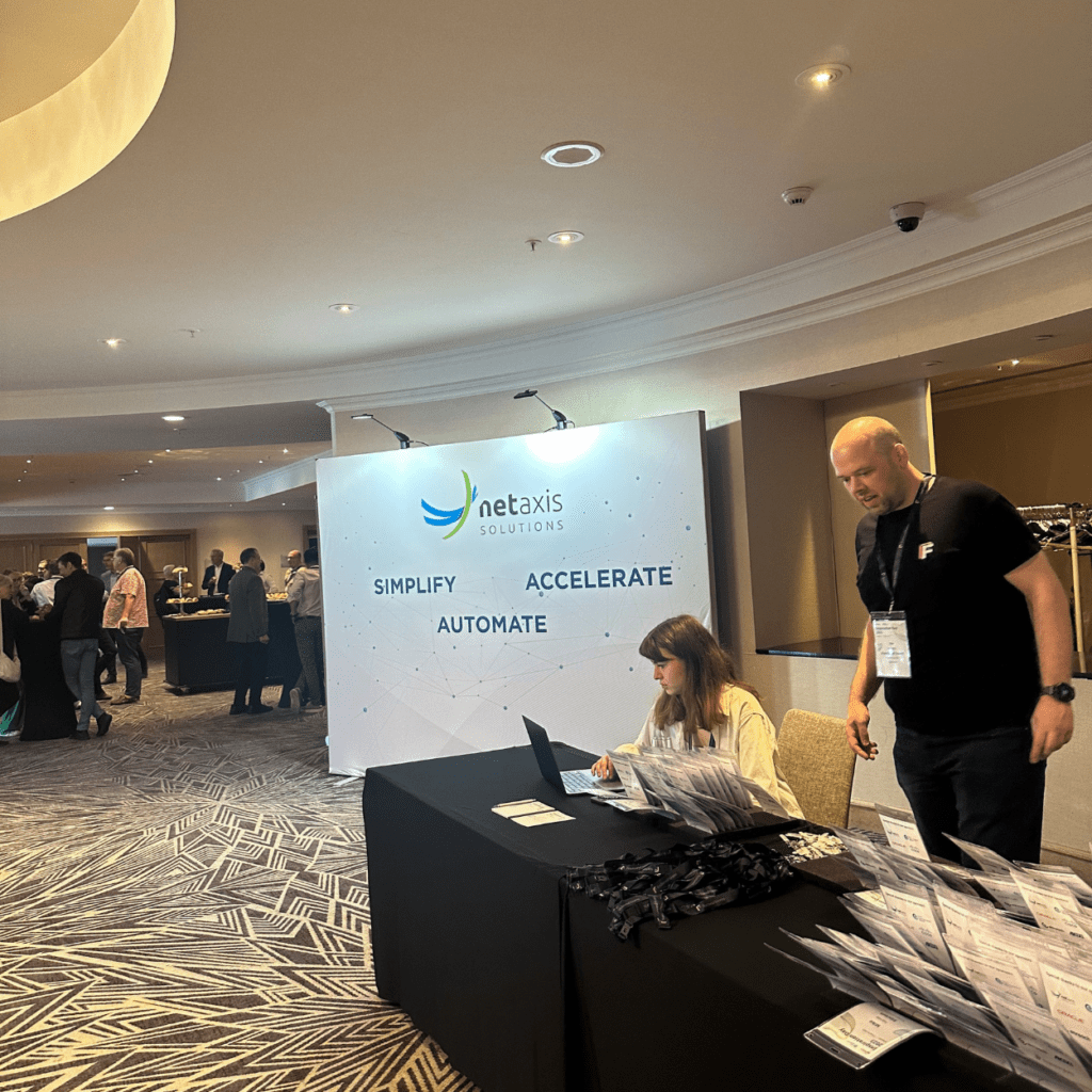 A women and a man standing at the registration desk at an event