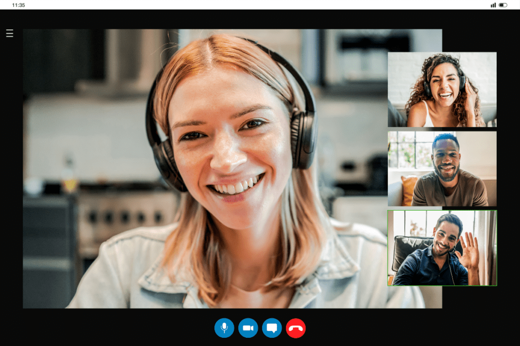 A woman wearing headphones is smiling and looking at the camera in a video call. Three smaller video call screens on the right show two men and a woman, all smiling and engaging in the call. The background suggests they are in different locations.