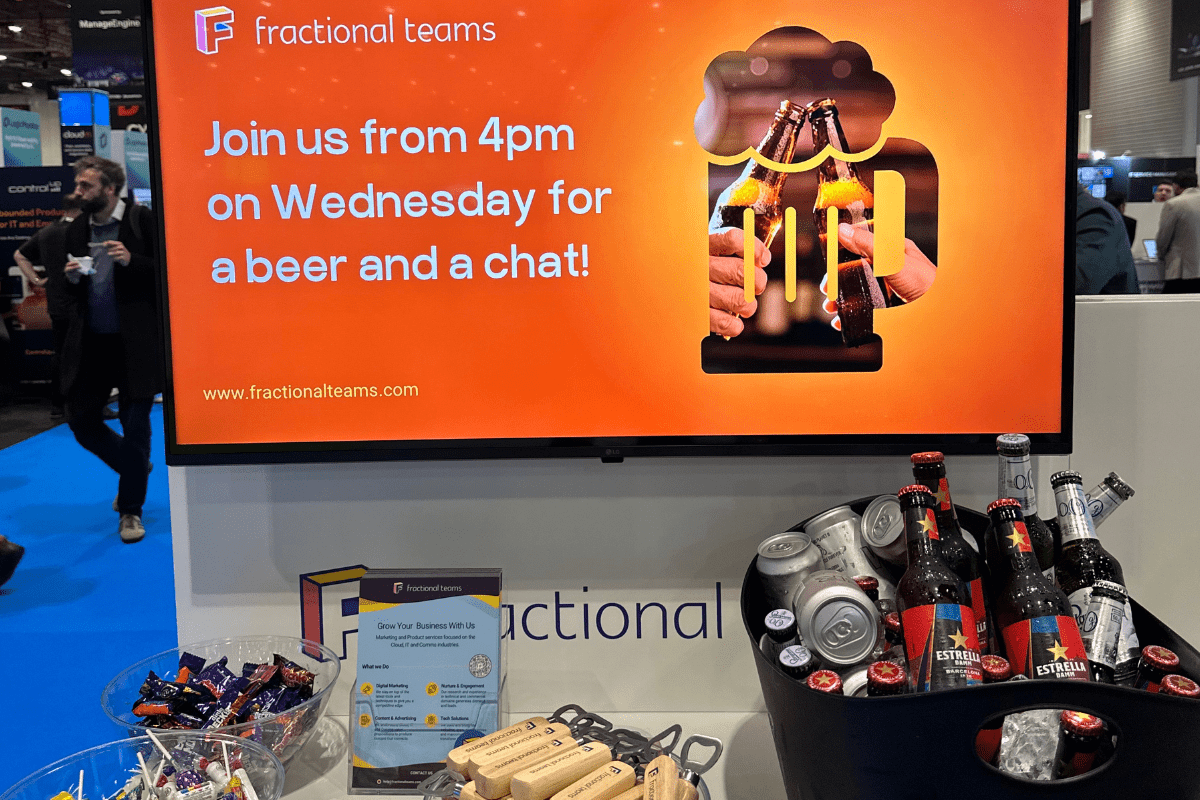 A display booth showcasing a screen with "Join us from 4pm on Wednesday for a beer and a chat!"